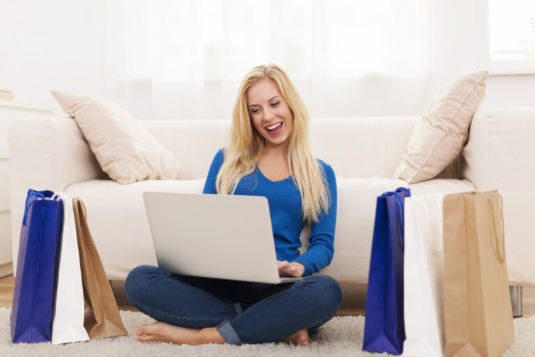 happy woman online shopping from laptop
